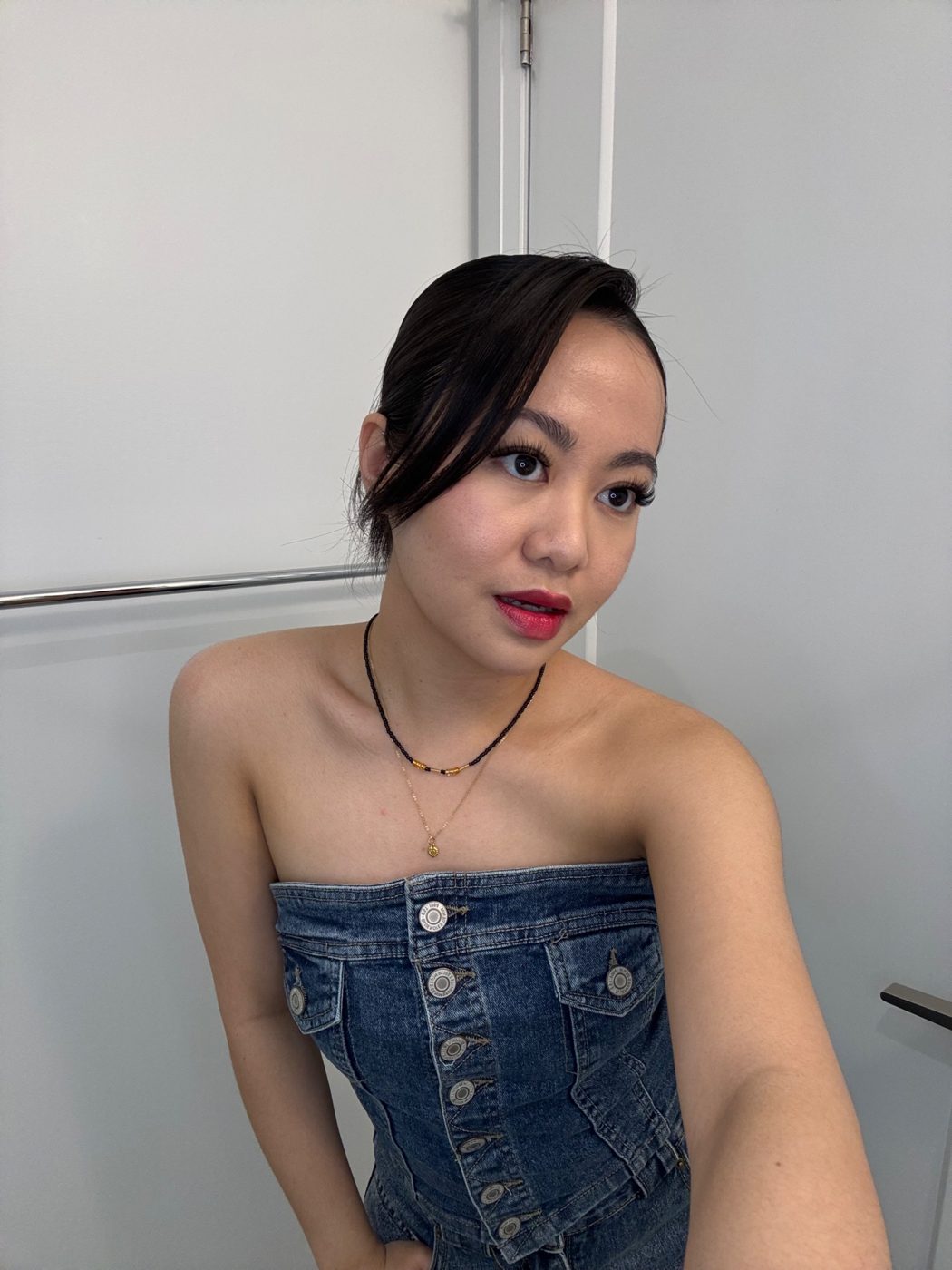 Cristine with a bold red lip in a denim top