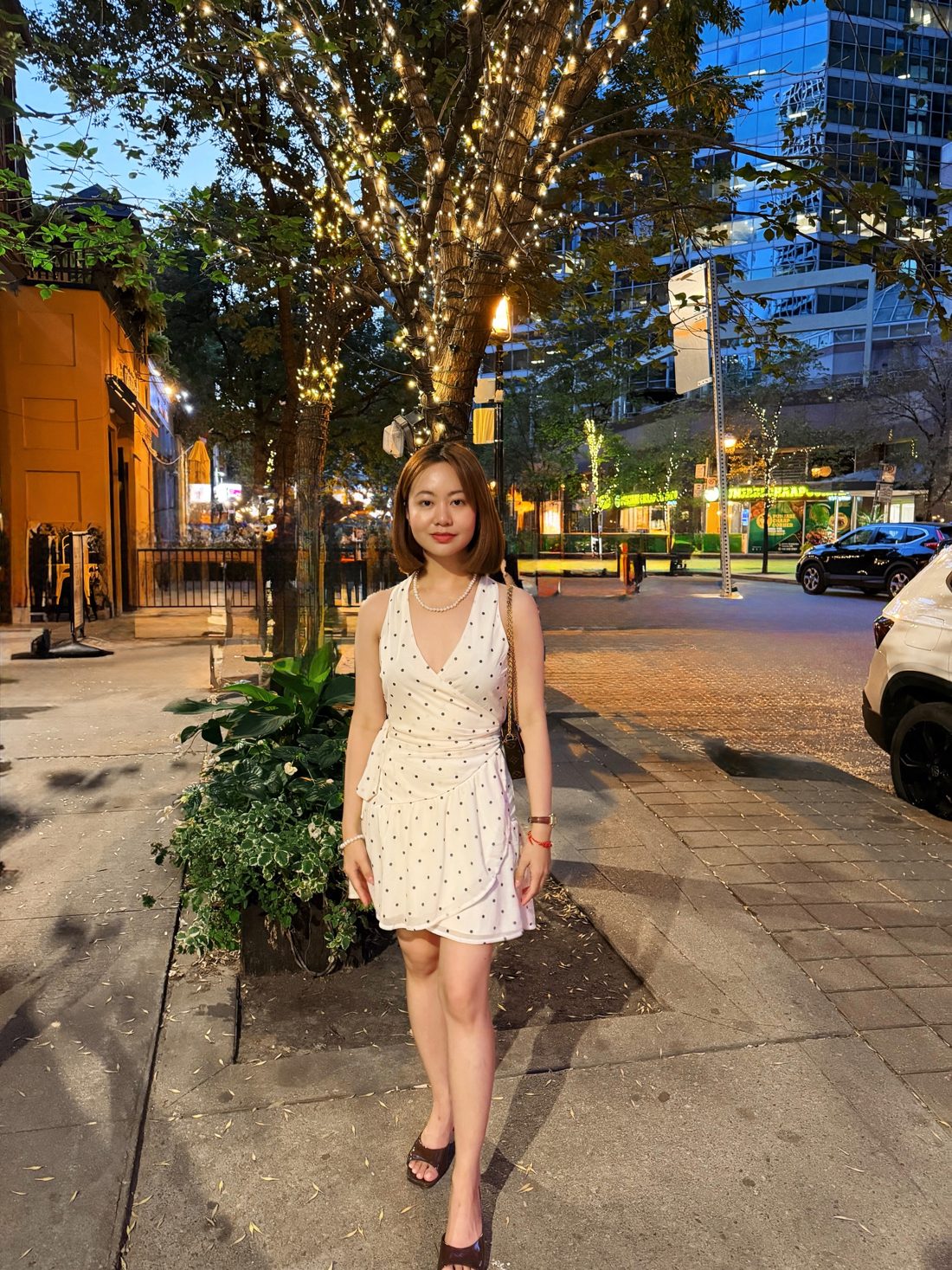 Cristine in a polka dot dress at night